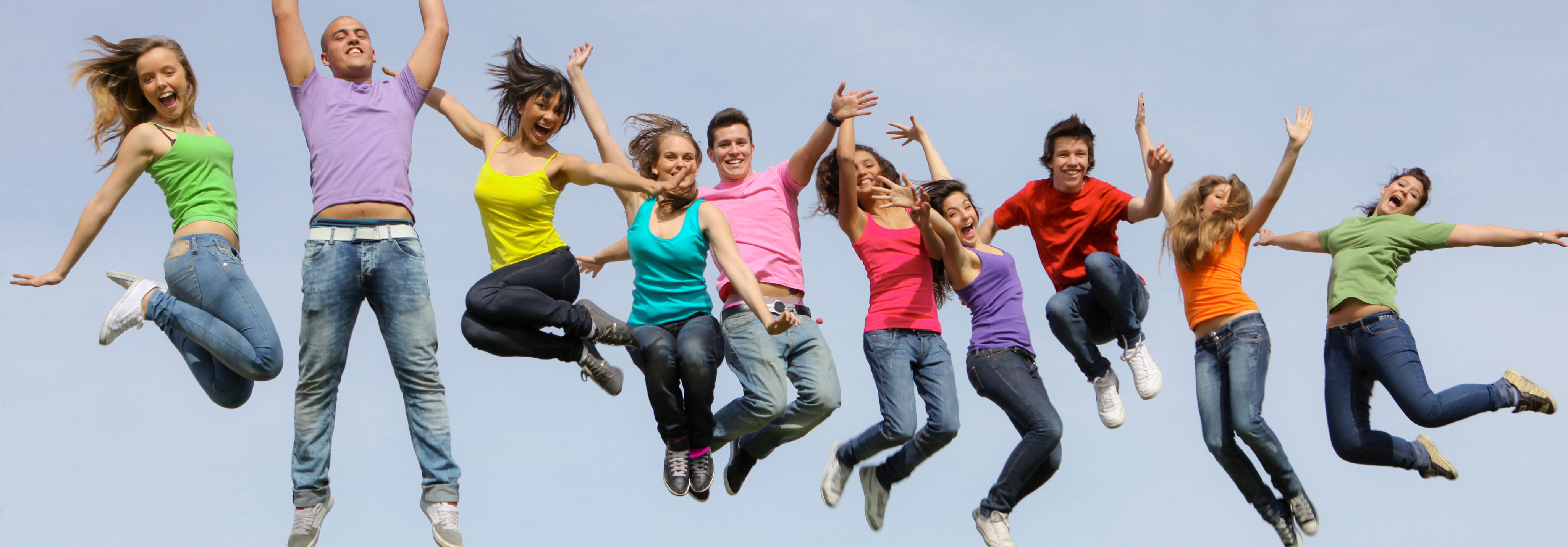 Gruppe ungdommar hoppar i lufta og smiler mot kamera.